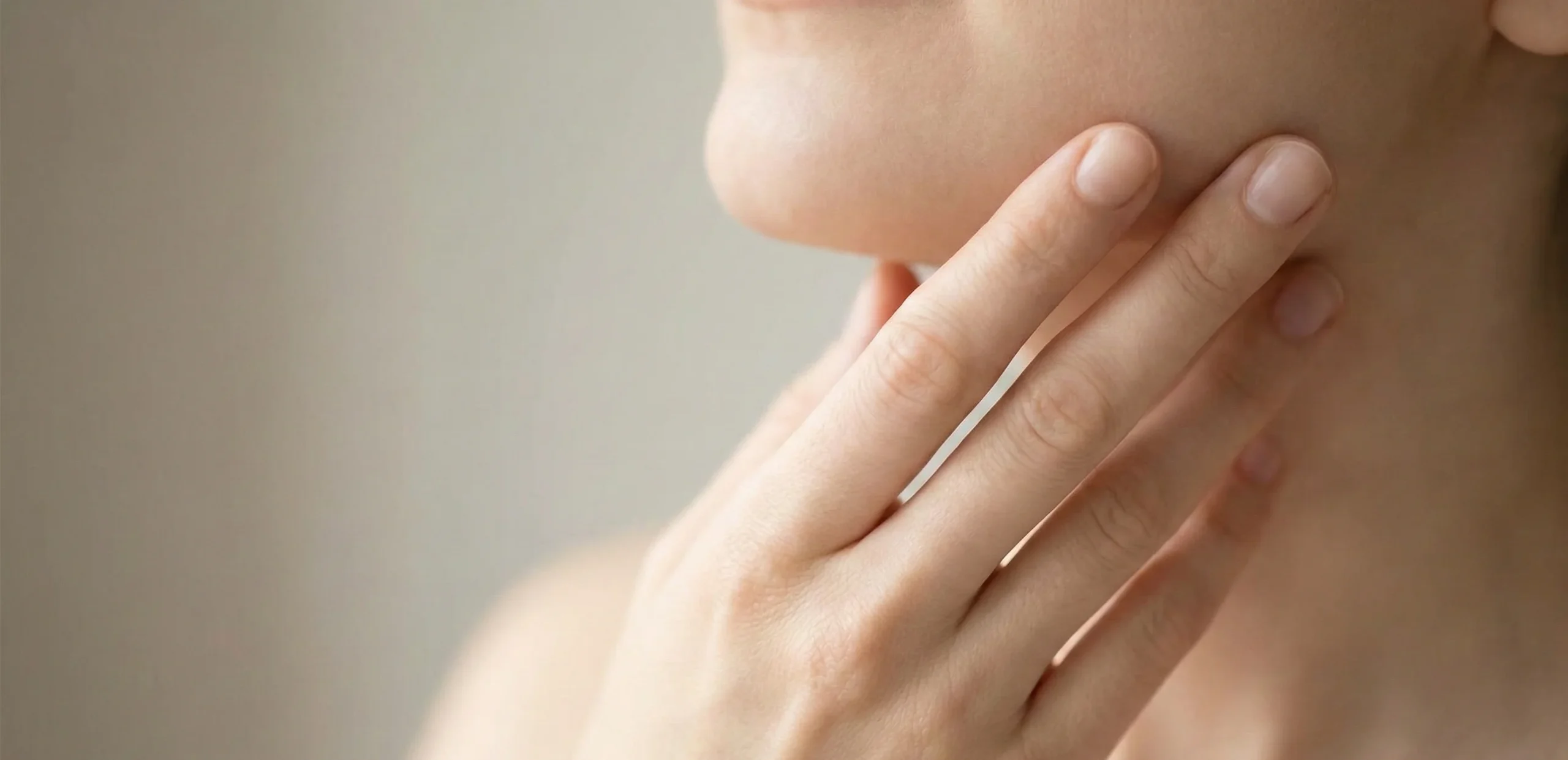 hand touching jawline natural light
