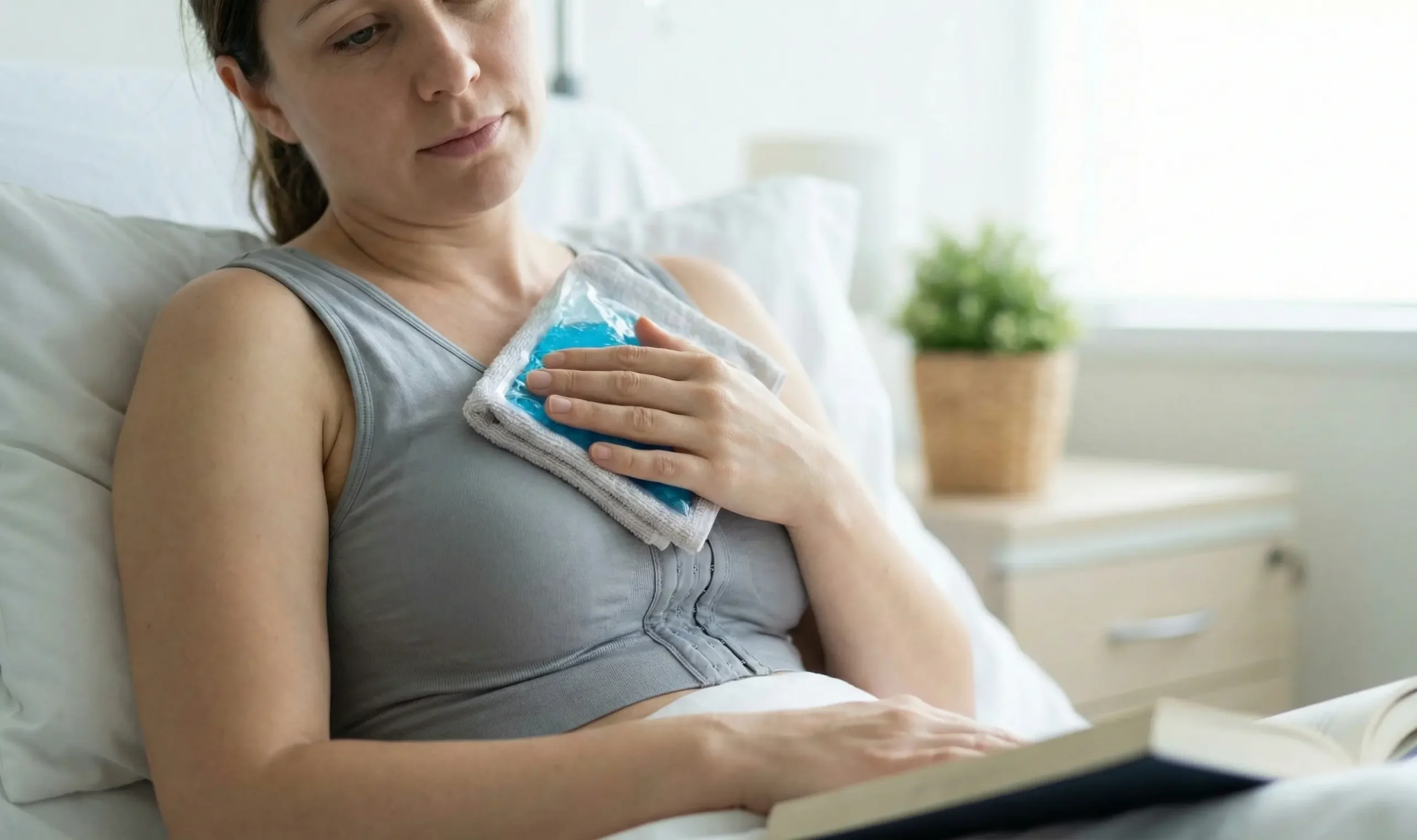 patient applying ice pack post breast surgery
