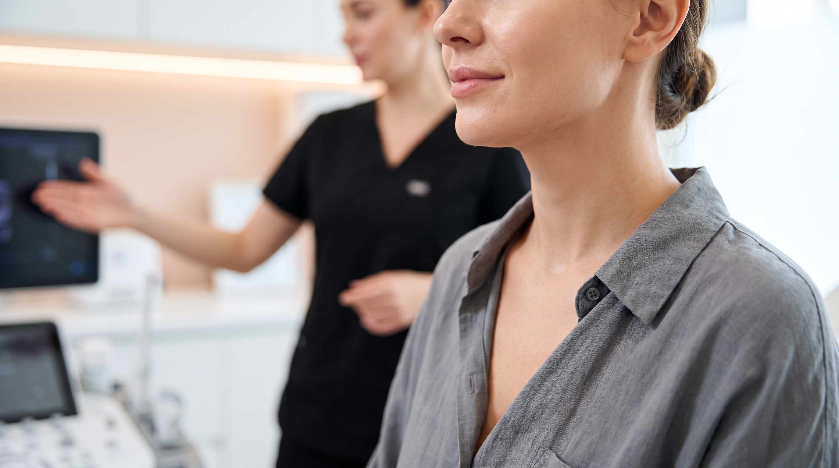 Profile view of a person's lower face and neck, illustrating submental adiposity, commonly known as a double chin.