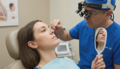surgeon examining columellar incision loupe