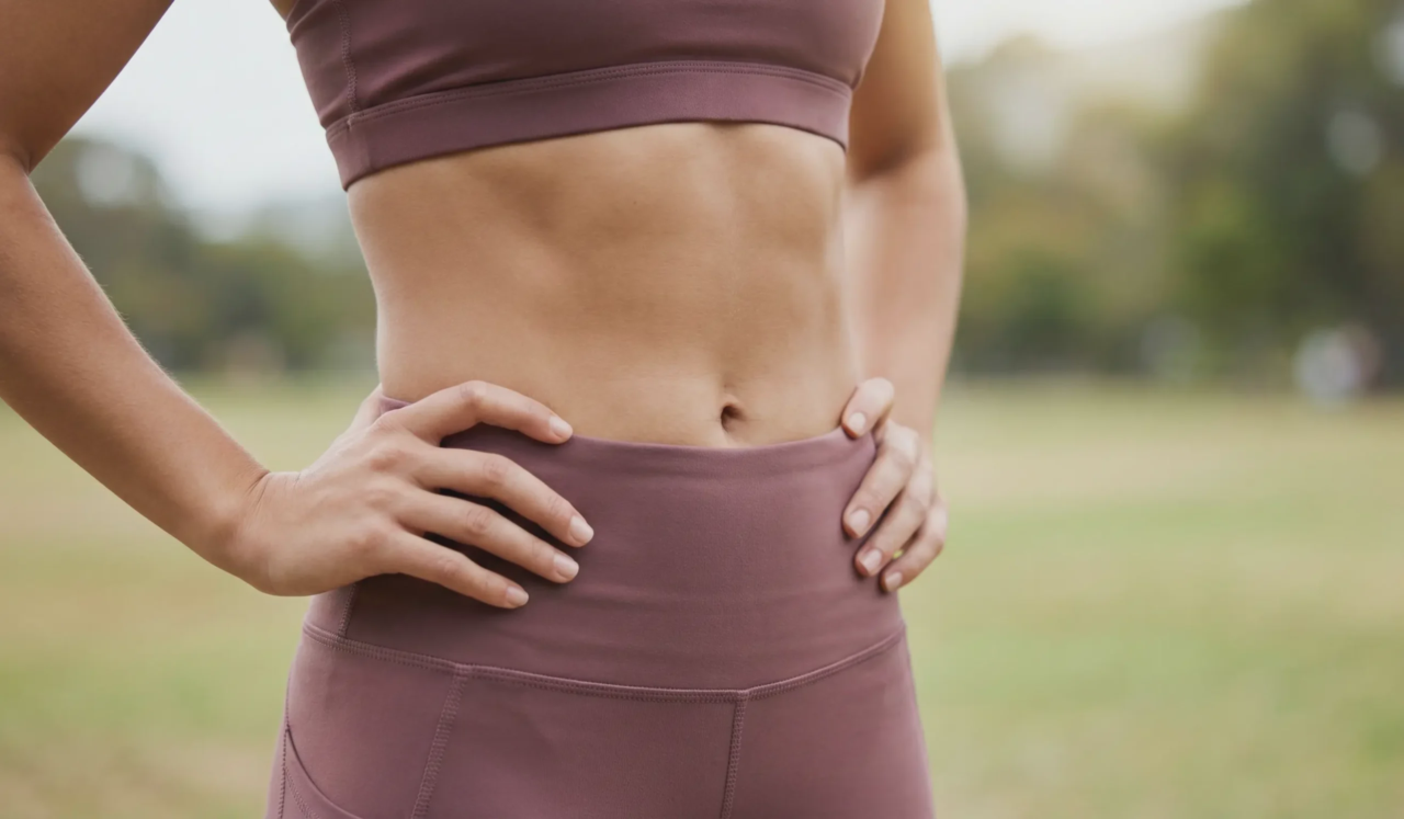 toned woman abdomen outdoor park