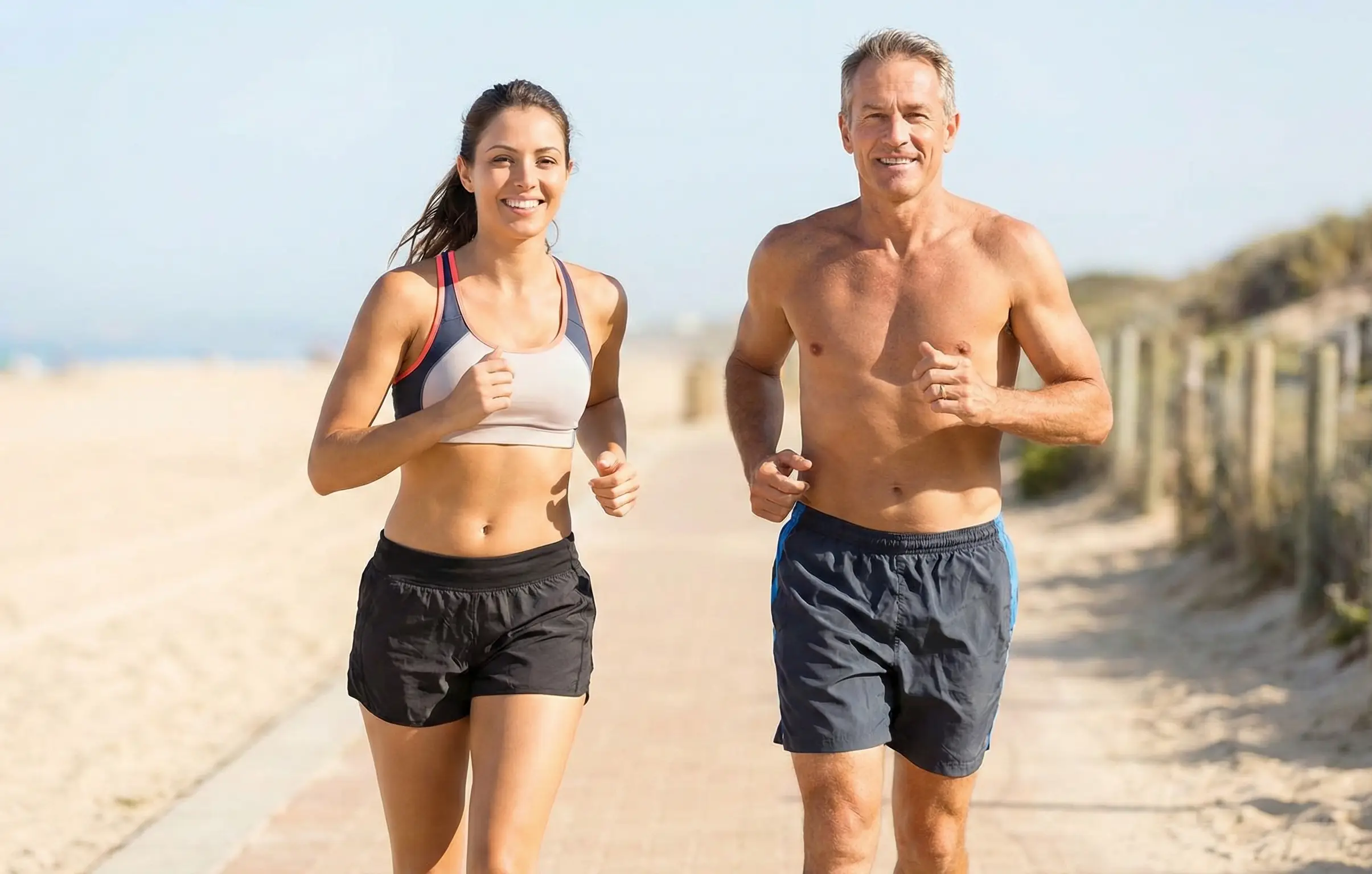fit man and woman jogging on beach representing active lifestyle at any age