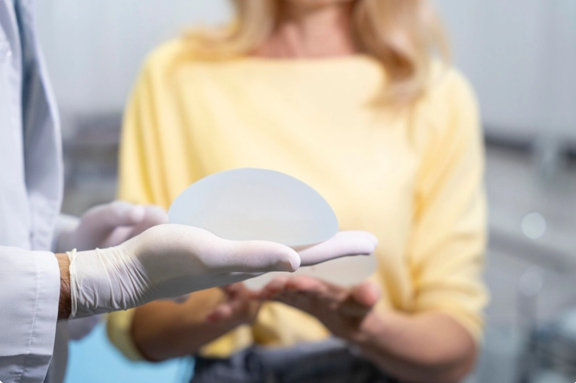 doctor holds a breast implant