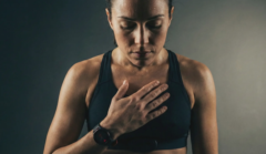 woman concentrating on heartbeat in athletic bralette
