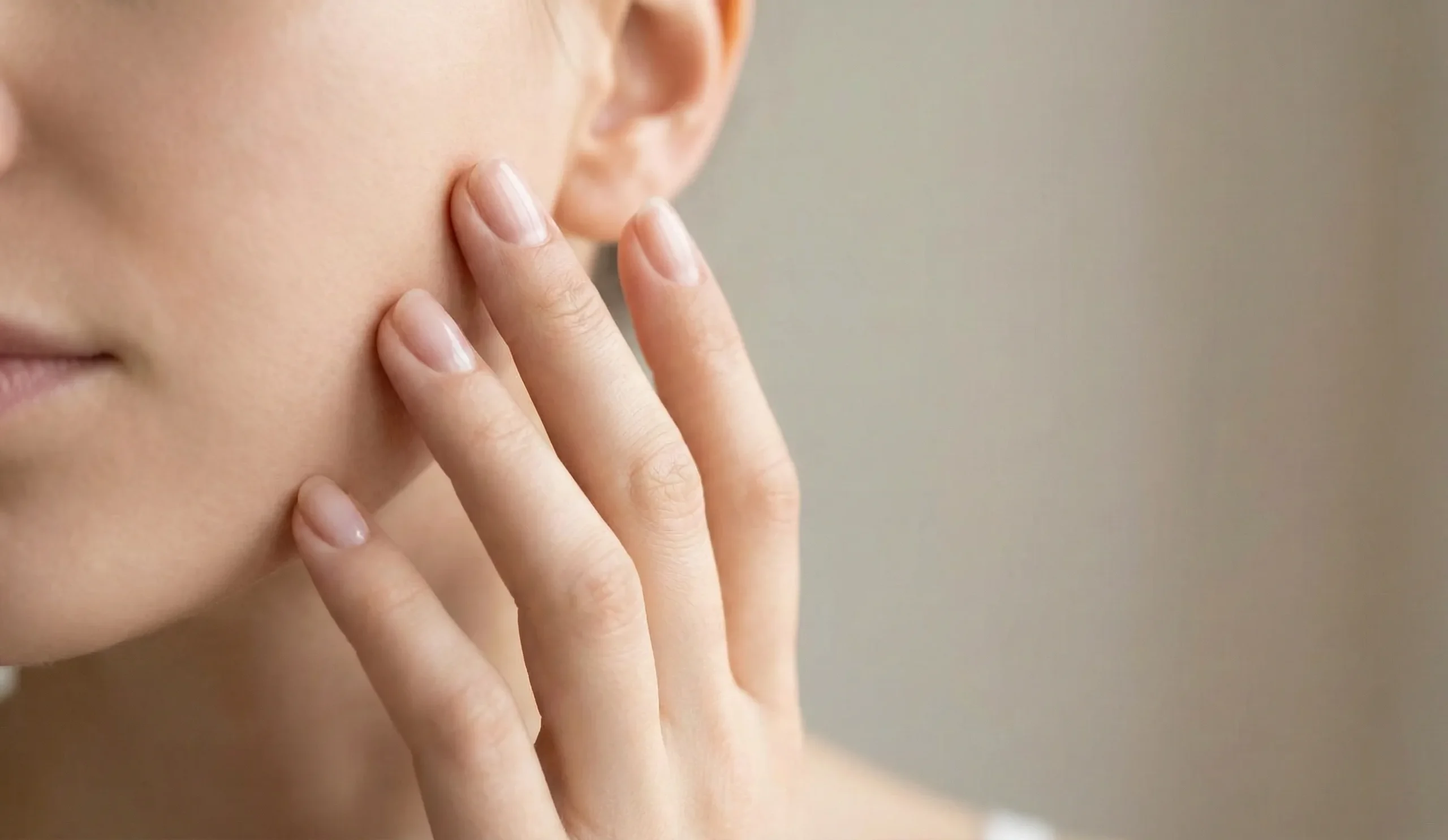 hand touching cheek natural light