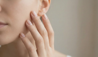 hand touching cheek natural light
