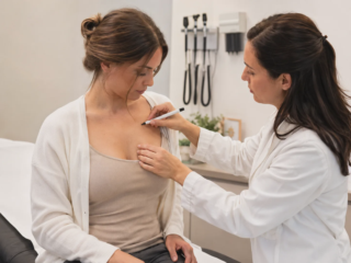 doctor examining breast tenderness