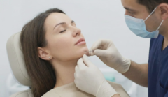 plastic surgeon performing microcannula liposuction on lower face
