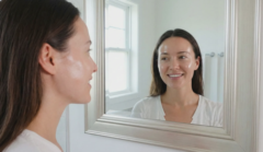 woman glass skin natural glow mirror reflection