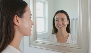 woman glass skin natural glow mirror reflection